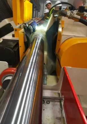 Coolant applied at the grinding zone of a cylindrical workpiece