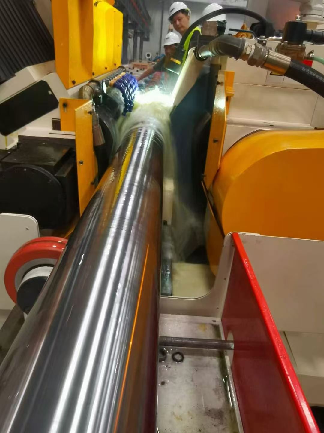 Coolant applied at the grinding zone of a cylindrical workpiece